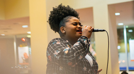 Student performing at Poetry Slam